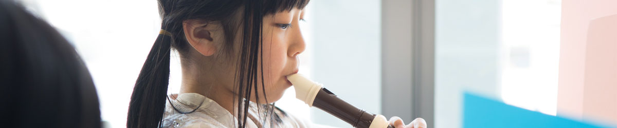 Girl learning to play recorder