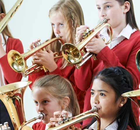 School children playing brass instruments